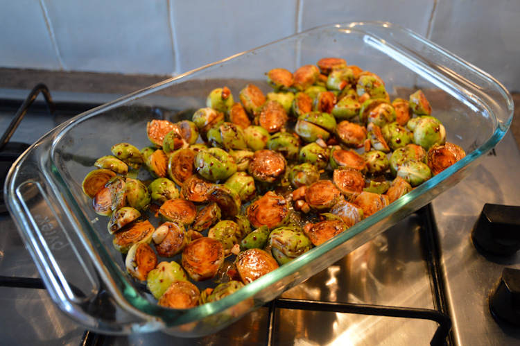 Spicy miso maple roasted brussels sprouts in a glass baking dish