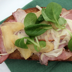 Close-up of Olomoucke Tvaruzky, meat, and greens on toast