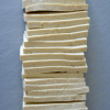 A stack of sliced tofu which will be turned into delicious Asian baked tofu