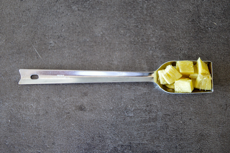 Small, but not minced, pieces of ginger in a teaspoon for the miso tofu marinade