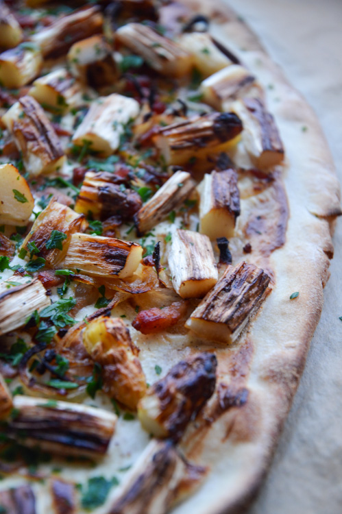 Close up of Flammkuchen with white asparagus including crust