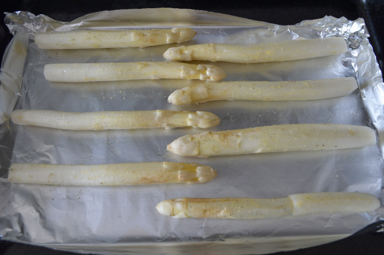 Roasted white asparagus prepped to cook in the oven