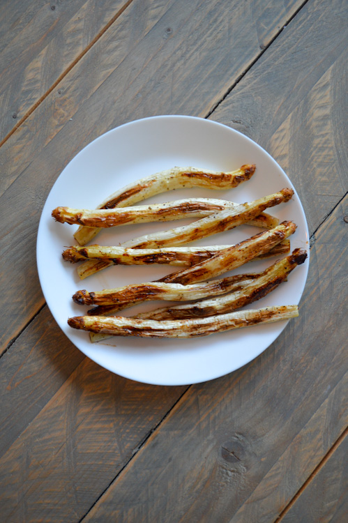 Plate of roasted white asparagus on a table