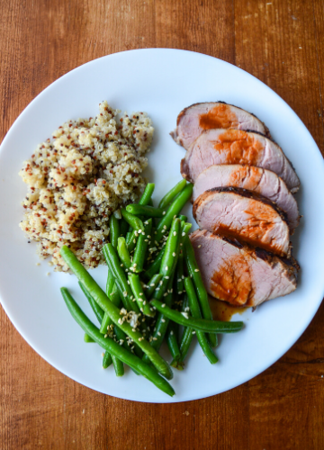 Thai Grilled Pork: sliced pork tenderloin plated with green beans and quinoa