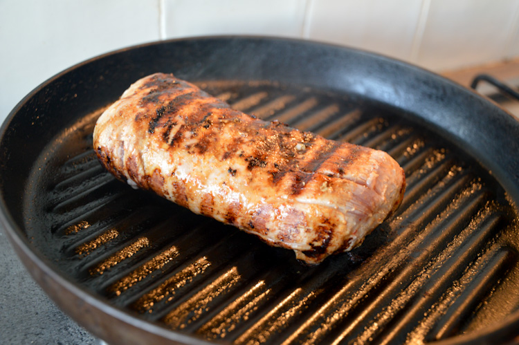 Grilled pork tenderloin cooking on a grill pan