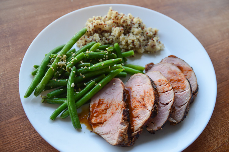 Thai Grilled Pork: pork tenderloin with sauce, green beans, & quinoa on a white plate