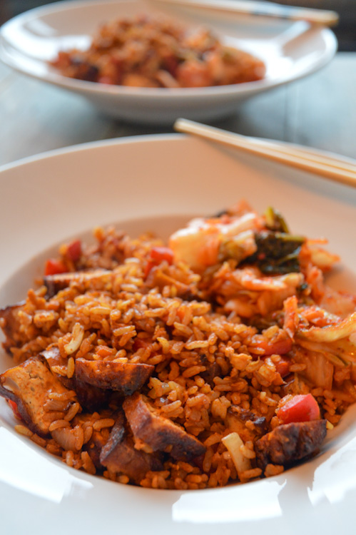 Two bowls of gochujang fried rice, one blurred in the background