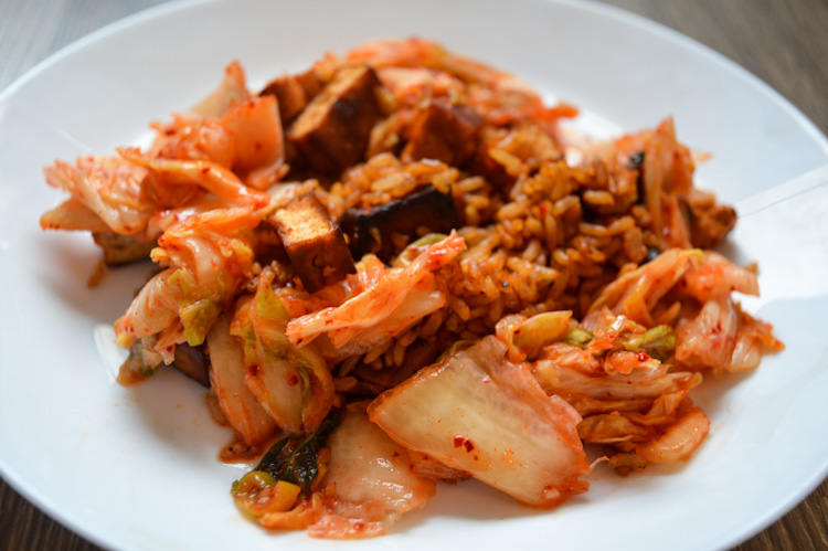 Close up of gochujang fried rice with kimchi and tofu on a white plate