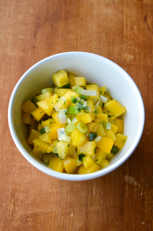 Mango jalapeño salsa in a white bowl on a brown table