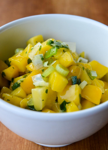 Close up of a white bowl with spicy mango salsa