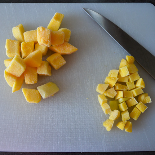 Frozen mango pieces chopped in different sizes