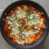 Shakshuka for two with feta and parsley in a skillet