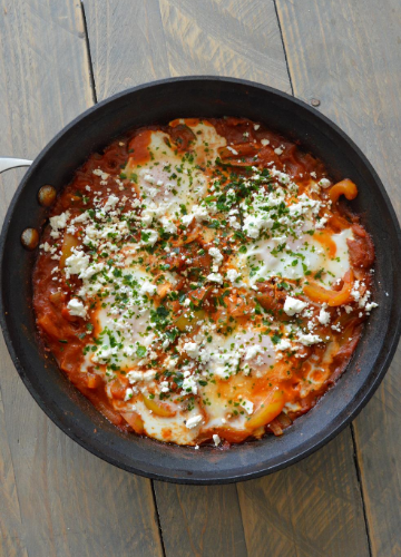 Shakshuka for two with feta and parsley in a skillet
