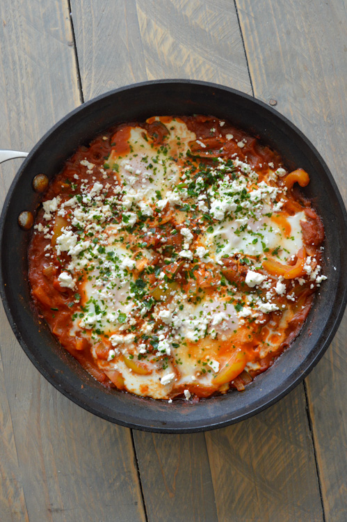 Shakshuka for two served in a skillet, topped with a sprinkle of feta cheese