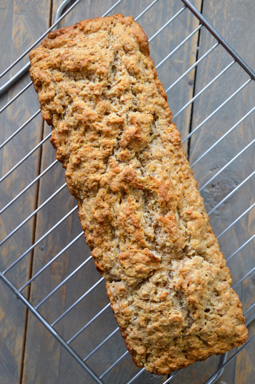 Loaf of whole wheat beer bread on a cooling rack