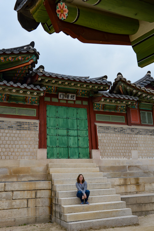 Sarah sitting on the stairs of a temple in Seoul, South Korea