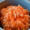 Carrot apple slaw in a blue bowl