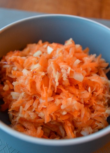 Carrot apple slaw in a blue bowl