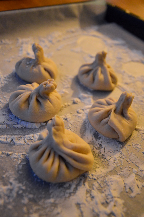 5 formed khinkali (Georgian dumplings) on floured parchment paper (almost in the dark because it was getting late!)