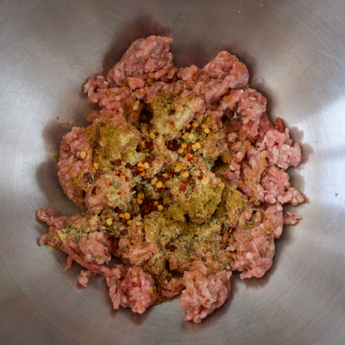Ground lamb with spices (khinkali ingredients) in a metal bowl