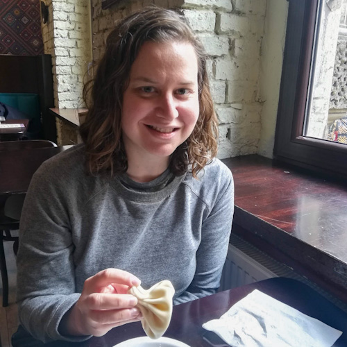 Sarah, a woman, very happy to be holding a single khinkali in Katowice, Poland