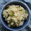 Small blue bowl of miso mashed potatoes on a green fabric background