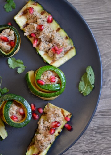 Half a black plate with several pieces of zucchini with Georgian walnut paste