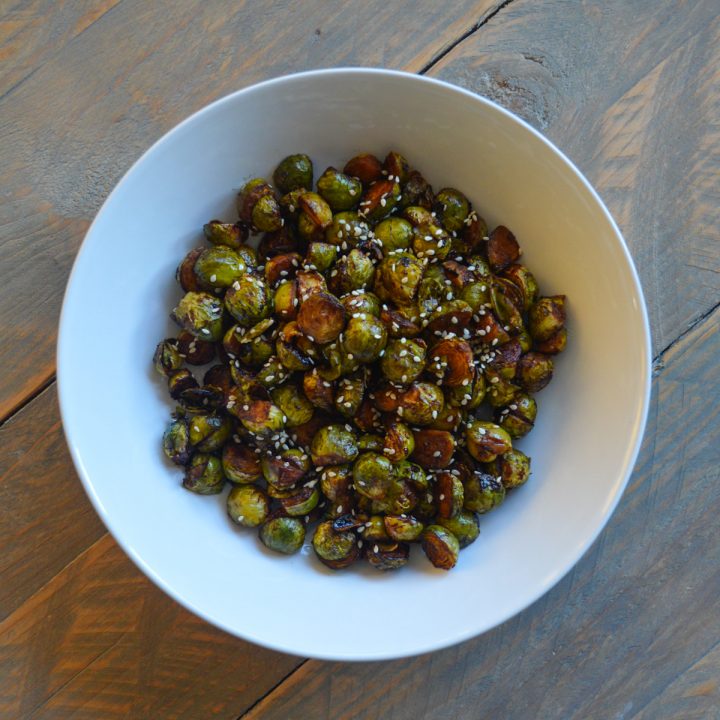 White bowl of hoisin roasted brussels sprouts
