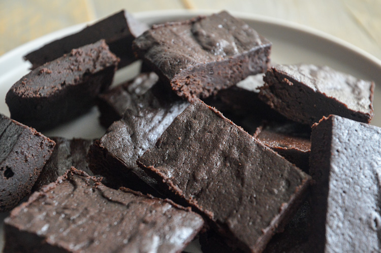 Top half of a plate filled with bourbon brownies