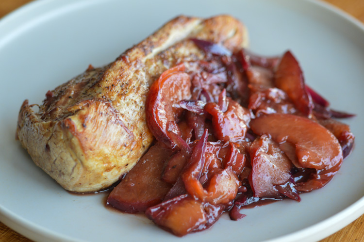 Plate of 5 spice pork tenderloin sitting next to hoisin plum sauce