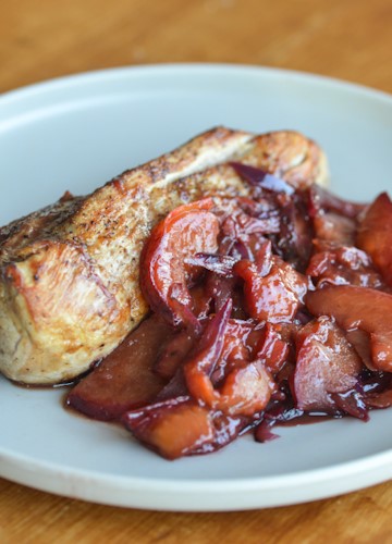 A plate with pork tenderloin and plum sauce