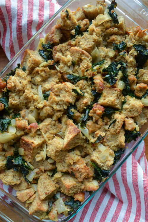 Overhead view of kale sausage stuffing on a white and red striped napkin