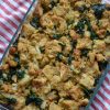 Overhead view of kale sausage stuffing on a white and red striped napkin