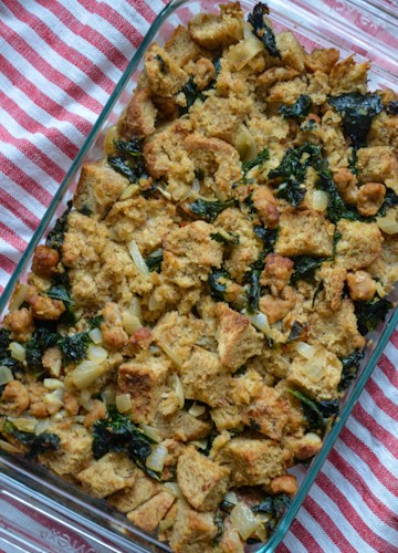 Overhead view of kale sausage stuffing on a white and red striped napkin