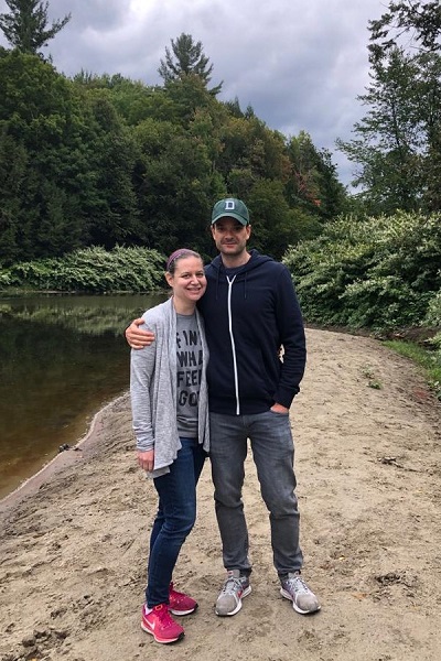 Sarah and Justin standing in front of a small stream